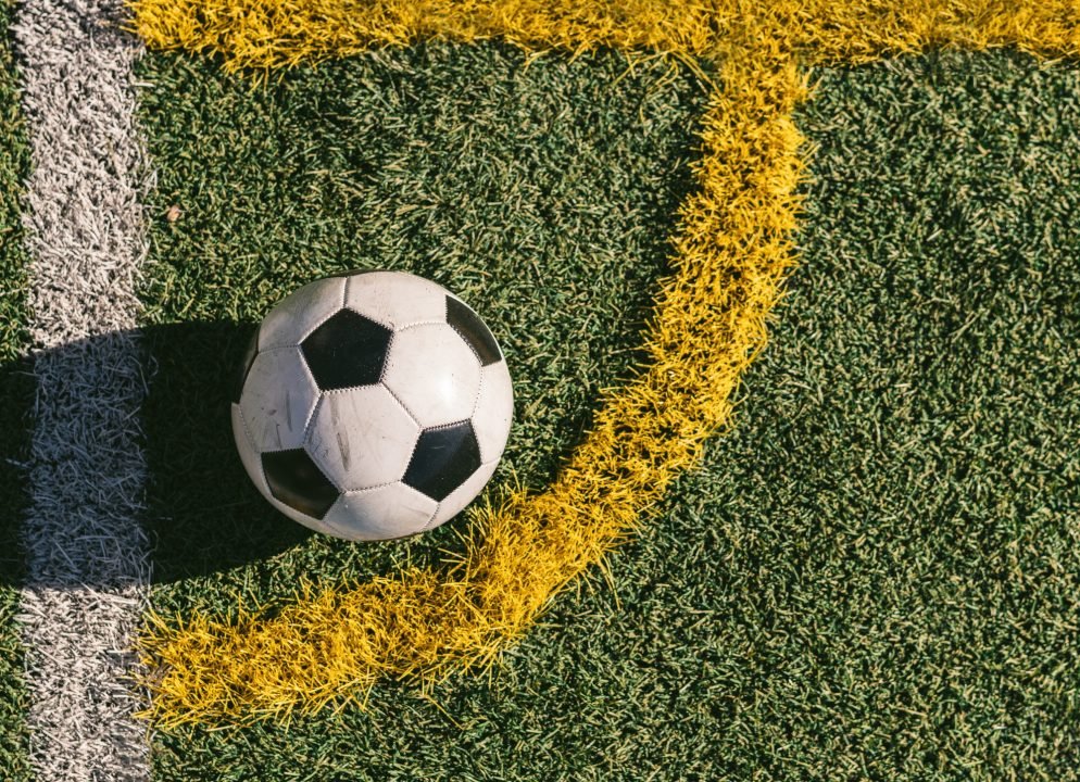 football placed in the corner of a football field